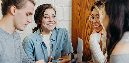 students in a group studying smiling