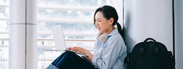 student studying on a computer sitting in an Iglu student accommodation in Sydney