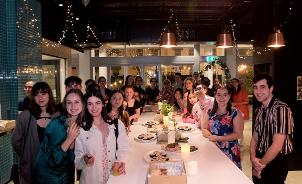 Well dressed students gathered for event with fairy lights at all-inclusive student accommodation