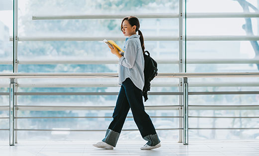 student walking in a corridor at university