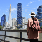 Rear view of adult woman looking at bridge across the Brisbane River in Brisbane, Australia.